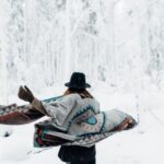 Downhill Running - Woman in poncho walking in winter forest