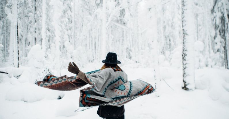 Downhill Running - Woman in poncho walking in winter forest