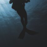 Swim Gear - Silhouette of scuba diver underwater