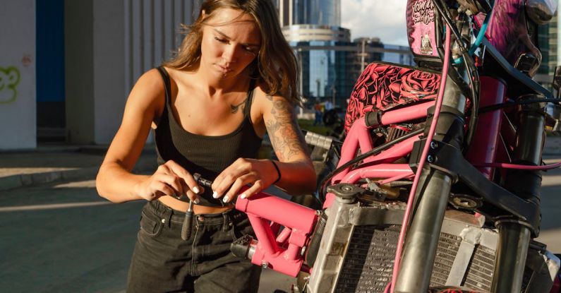 Bike Tools - Woman Fixing Her Motrbike on a Street in City