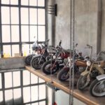 Bike Storage - Retro motorbikes parked in row on special platform in garage