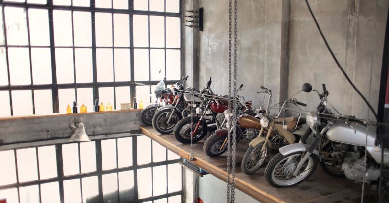Bike Storage - Retro motorbikes parked in row on special platform in garage