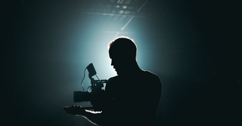 Triathlon Gear - Silhouette of Man Standing in Front of Microphone