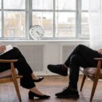 Stride Analysis - Person in Black Pants and Black Shoes Sitting on Brown Wooden Chair