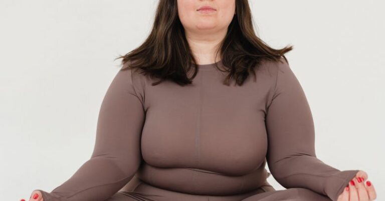 Training And Recovery - Serene plus size female meditating in Lotus pose