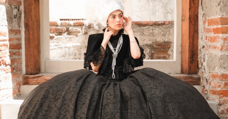 Periodization - Woman Posing in a Period Costume in Front of a Building