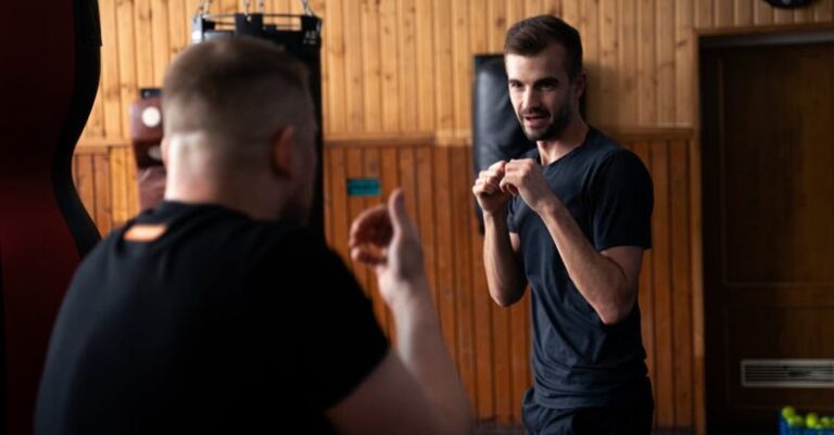 Training Consistency - Two men in a gym doing some boxing