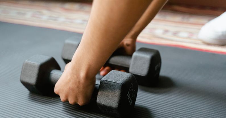 Strengthening Techniques - Person Holding Black Dumbbells