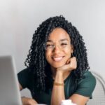 Positive Mindset - Happy ethnic woman sitting at table with laptop