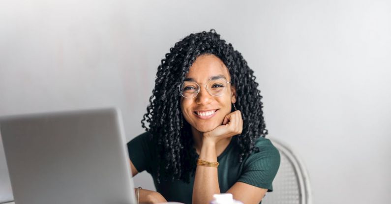 Positive Mindset - Happy ethnic woman sitting at table with laptop