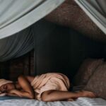 Sleep - Woman Lying on Bed wrapped around a Towel